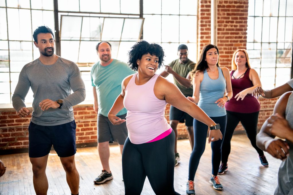 A diverse group of individuals taking part in exercise to music